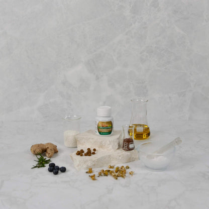 Herbal ingredients and bottles on a textured gray surface